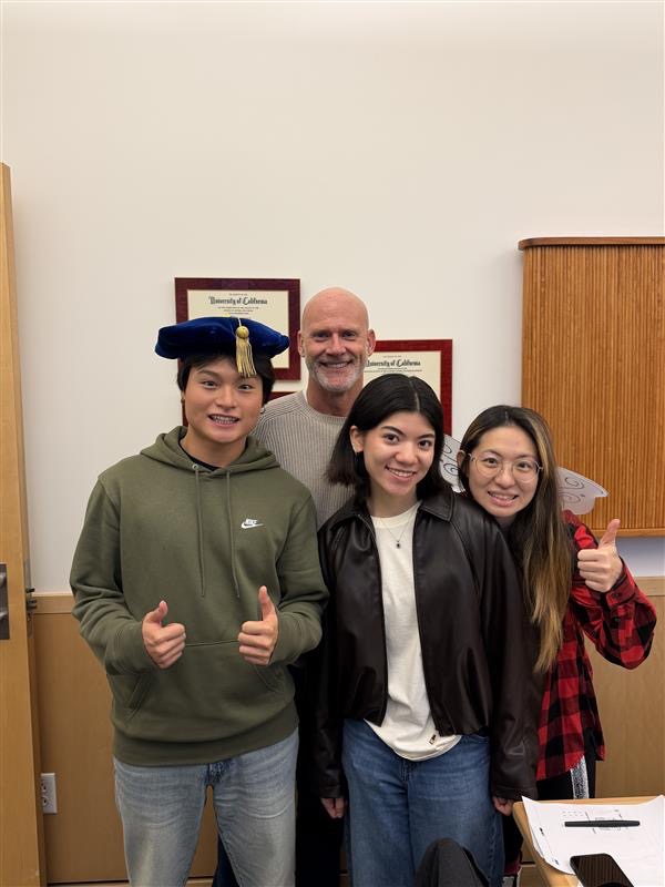Students Morgan, Mia, and Emma in the front row and College President Eric Murray in the back row.