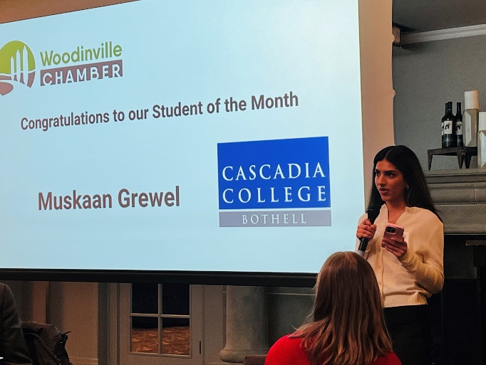 Muskaan Grewal presenting next to a slide show