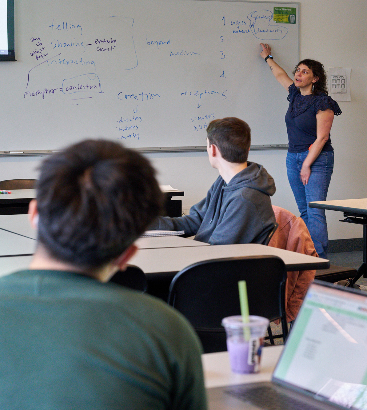 A student attentively focus on the professor teaching.