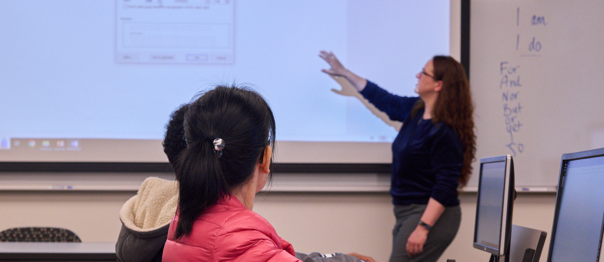 A student reading in front of a computer, demonstrating a focused and studious approach to online learning or research.