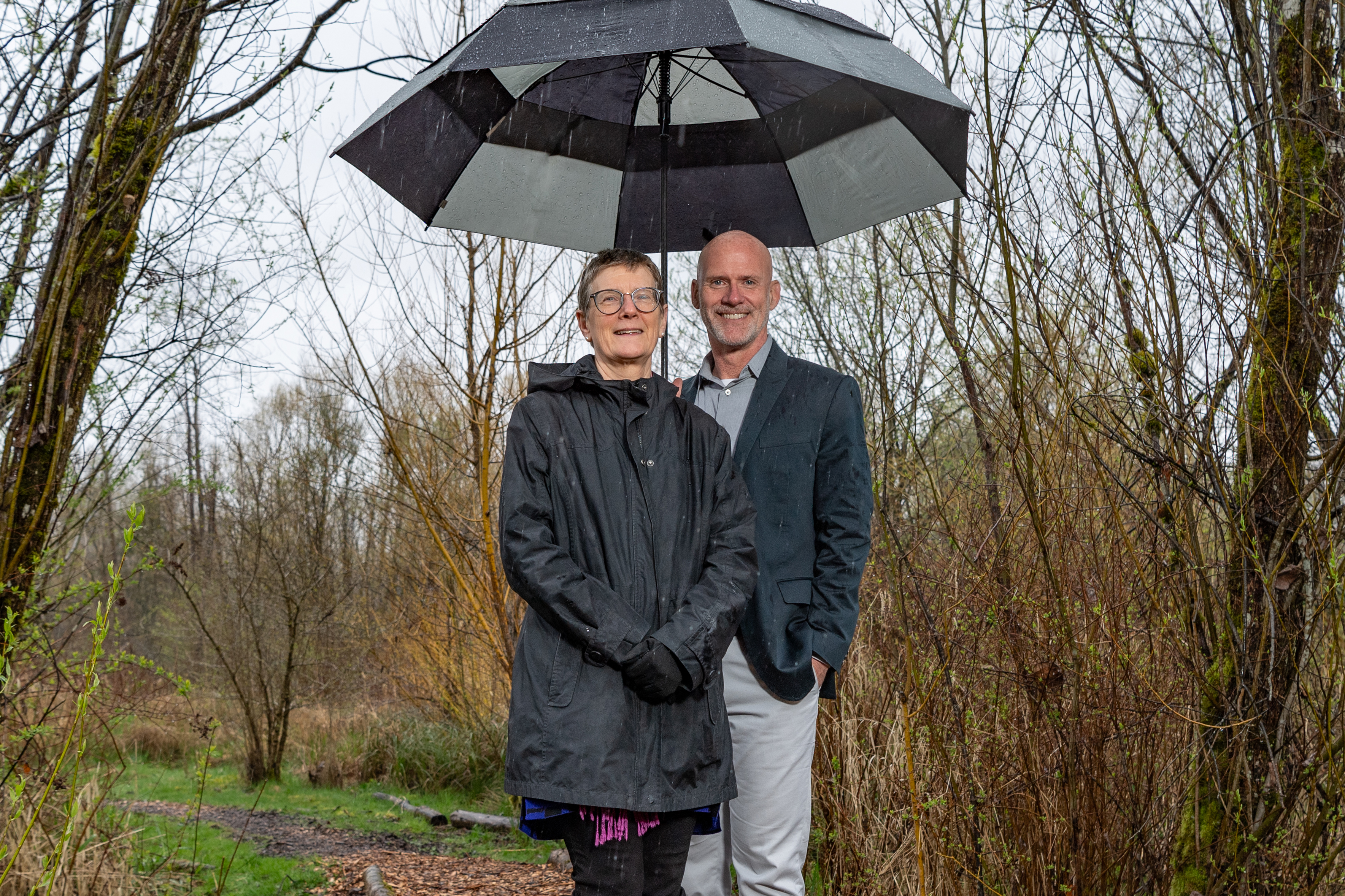 President Murray and Chancellor Esterberg under an umbrella in the wetland