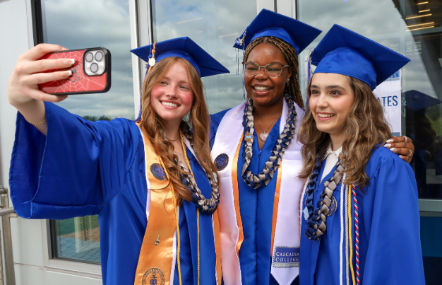 Graduates taking a selfie.