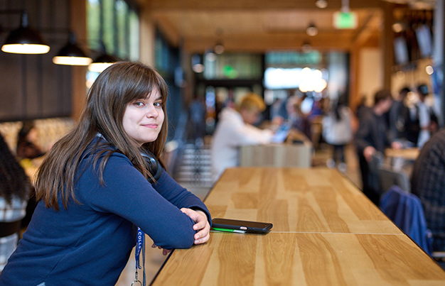 Student at the cafeteria smiling.
