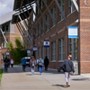 people walking along a Cascadia College path by CC1 building