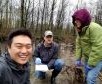 three students outside in the wetland