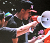 Student with bullhorn talking to crowd of students in mock protest for class