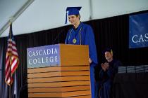 Valedictorian speaking on stage behind the podium at the ceremony